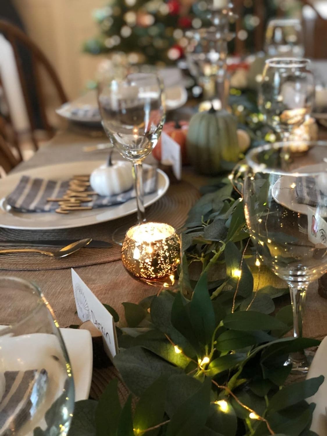 Volens gold mercury glass tealight holders on a dining table create a warm glow.