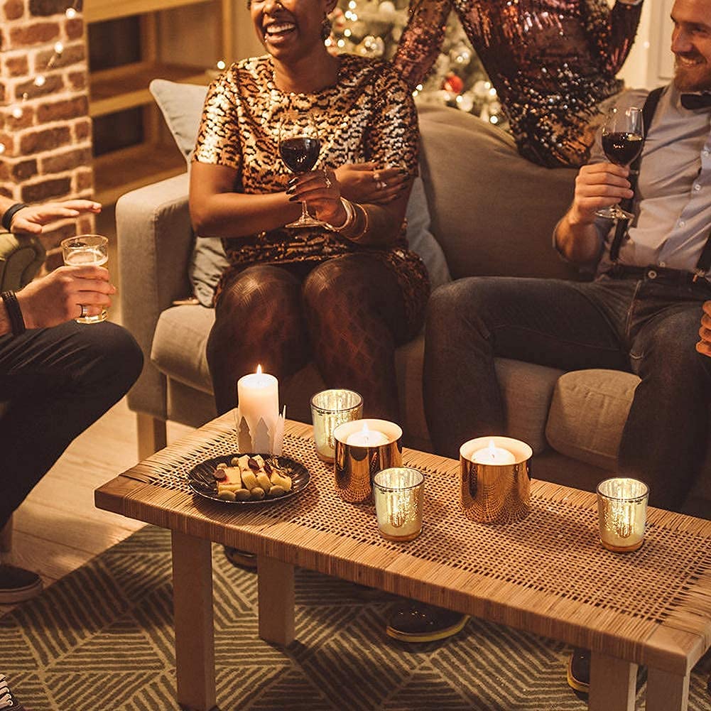 Volens votive holders on a candlelit table create intimate ambiance.