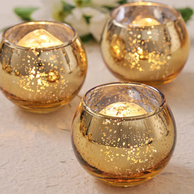 Volens gold votive holders with round mercury glass enhance table centerpieces