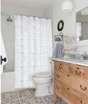 Volens white shower curtain measures about 70x70 inches for standard tubs.