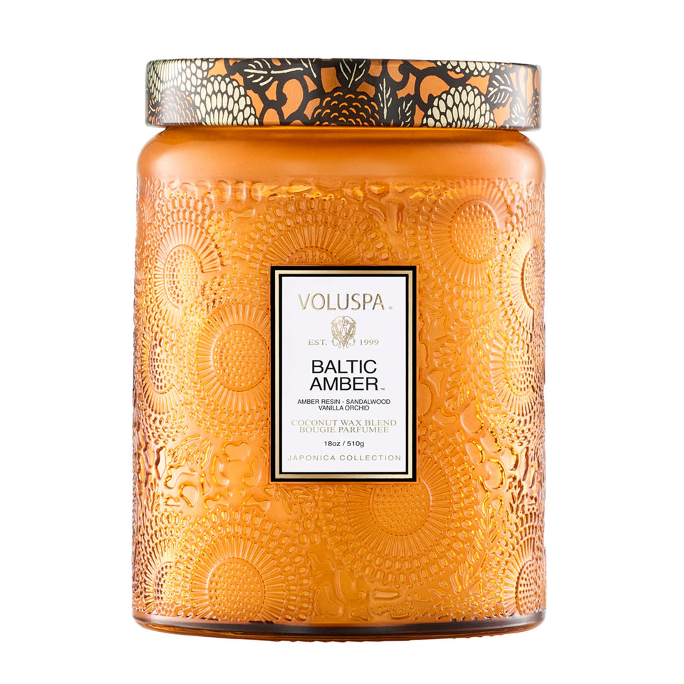 Voluspa Baltic Amber candle 18 oz on a decorative surface, creating warm ambiance