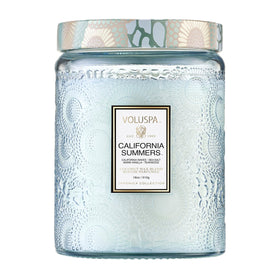 Voluspa California Summers candle in embossed glass jar enhances home ambiance.