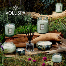 Voluspa candle in softly lit room demonstrates calming ambiance.
