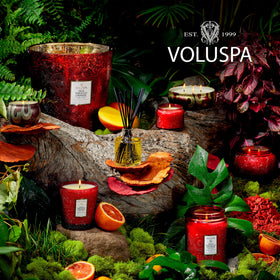 Voluspa Goji Tarocco Orange diffuser near a candle creates inviting ambiance.