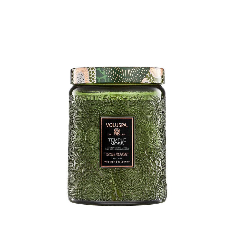 Voluspa Temple Moss candle jar with warm earthy scent for calm evenings.