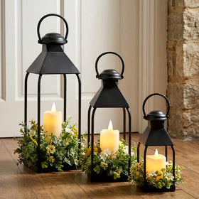 Vorplick decorative metal lanterns on porch setup highlight entryway in warm, welcoming style.