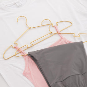 VWV gold aluminum hangers with shoulder groove for slim garments and secure hanging.