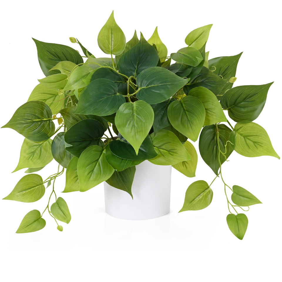 Waipfaru faux plants in a white pot brighten a living space.