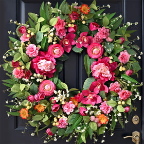 Waipfaru spring wreath on front door, bold 26-inch welcome feature.