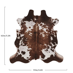 Warm Haven cow-hide rug cow print used in a bedroom for warm ambiance and versatile styling.