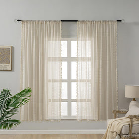 WAZZIO tassel-detail crochet curtains add boho charm as decorative focal point.