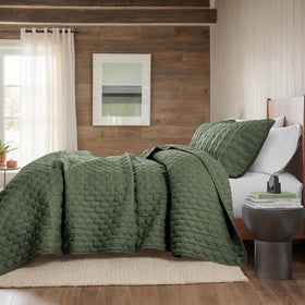 WDCOZY olive green quilt draped on a California King bed in bedroom
