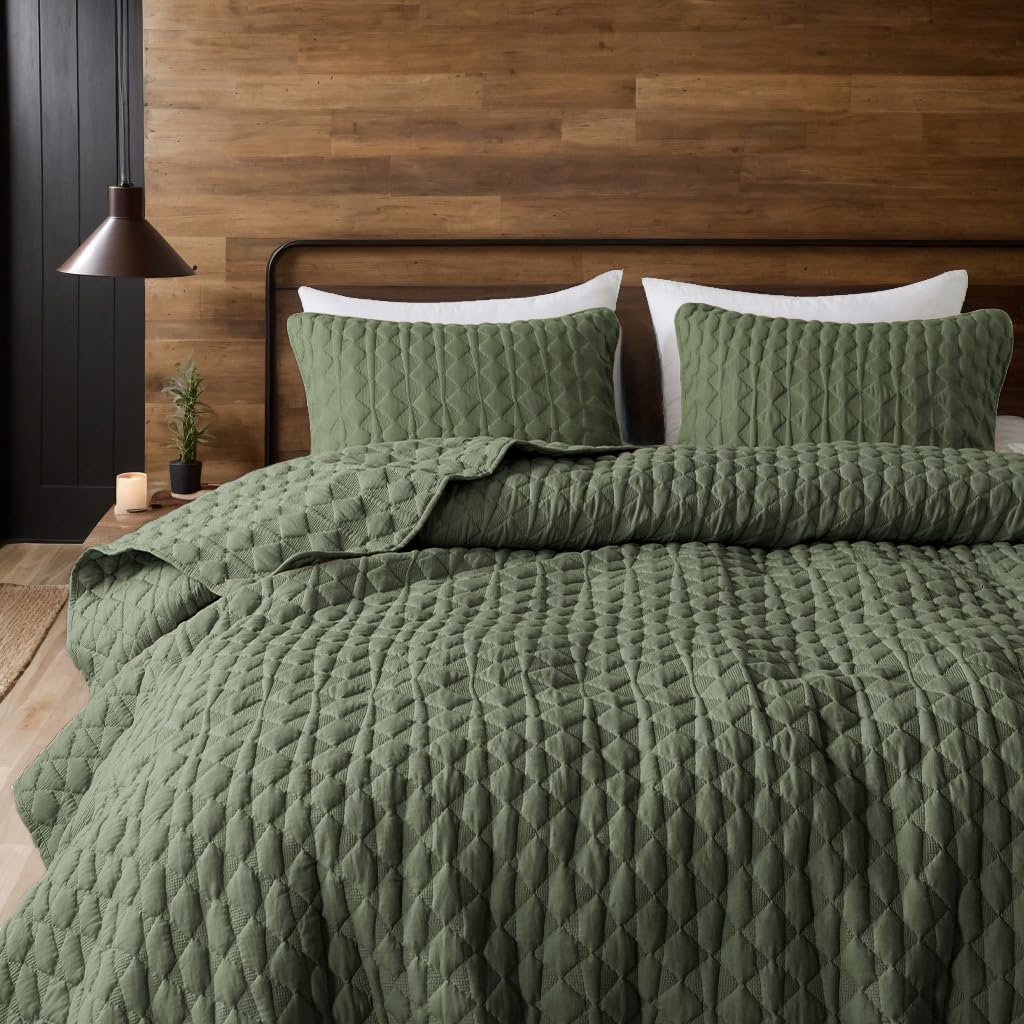 WDCOZY olive green quilt folded beside two shams on bed