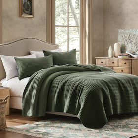 WDCOZY close-up of olive-green striped quilt showing textured pick-stitch for farmhouse charm.