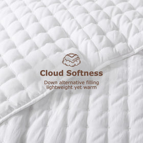 WDCOZY White Cloud Quilt on bed with shams, draping gracefully for a rustic look.