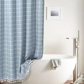 WEGOMA boho curtain blue tassels enhance texture and style in any shower.