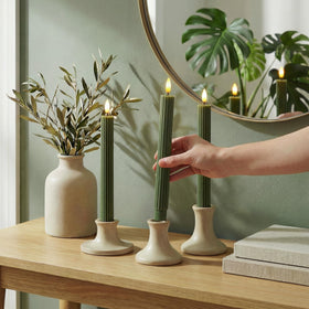 West Ivory remote-controlled LED candle showing brightness and timer options.
