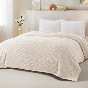 Whale Flotilla fuzzy fleece queen blanket on couch serves as a quick style upgrade