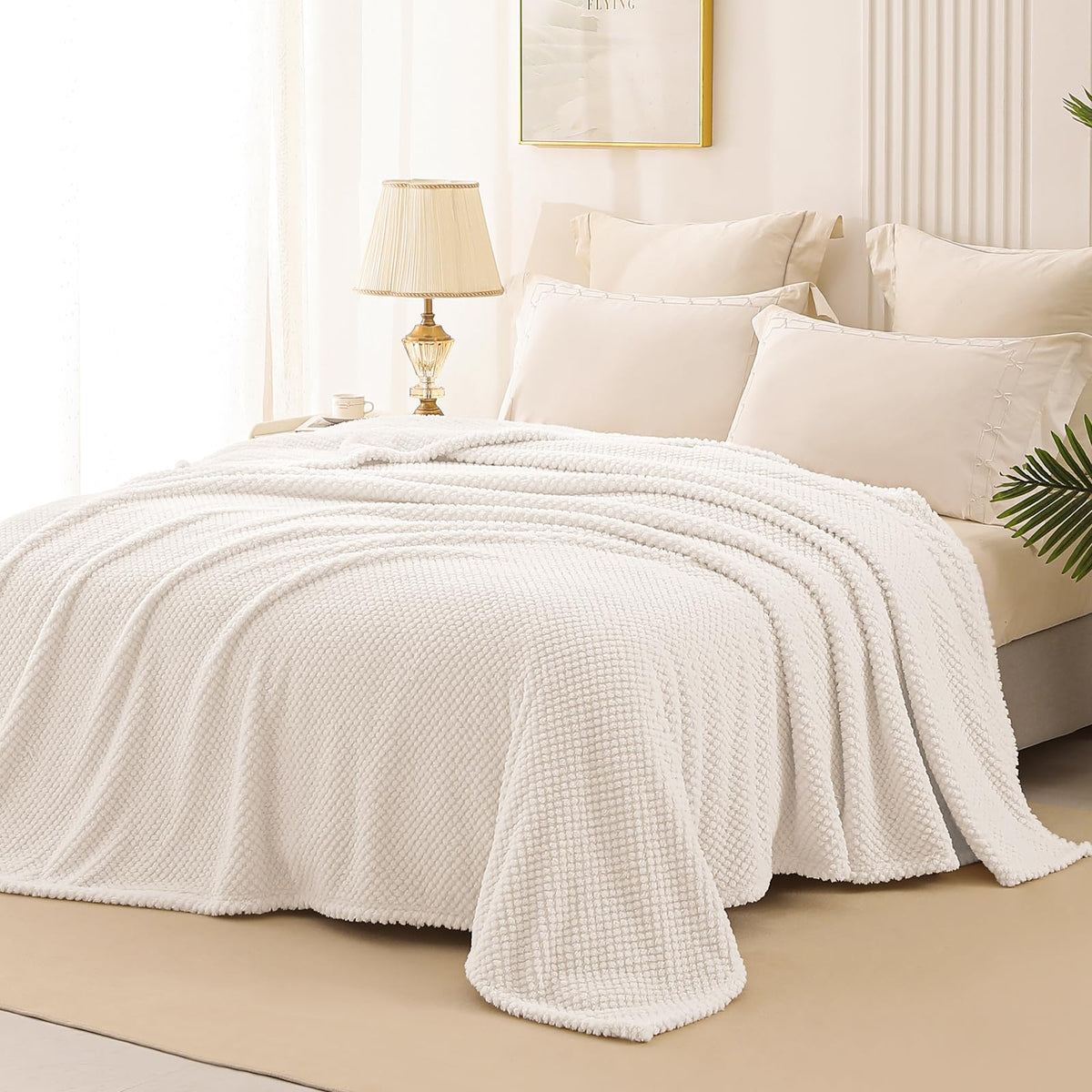 Whale Flotilla lightweight blanket draped on bed offers versatile all-season warmth.