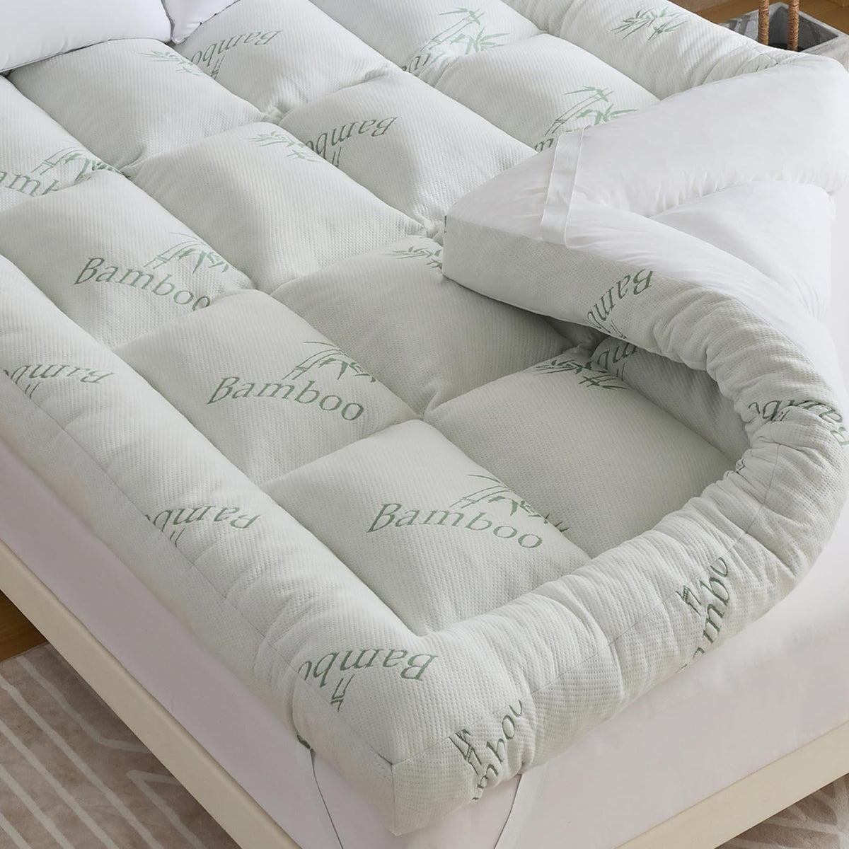 WhatsBedding 5 Inch memory foam topper sits on a king bed for plush support.