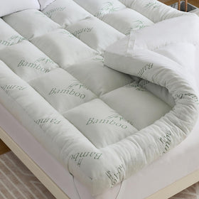WhatsBedding 5 Inch memory foam topper sits on a king bed for plush support.