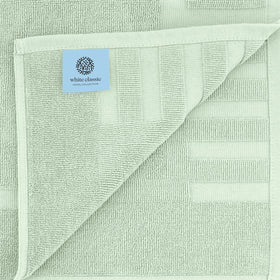 Two-pack White Classic bath mats ready for use in the bathroom