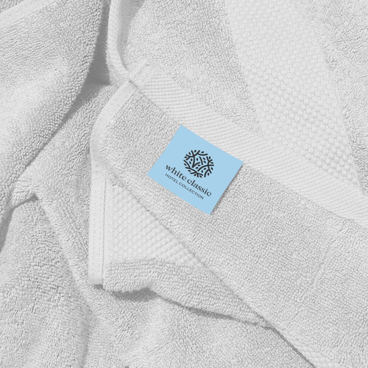 White Classic towel with double-stitched edges highlighting durability.
