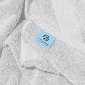 White Classic towel with double-stitched edges highlighting durability.