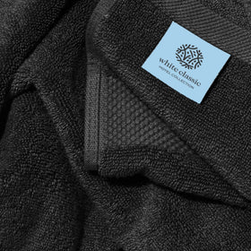 White Classic lint-free black bath towels designed to minimize fuzz after washing.