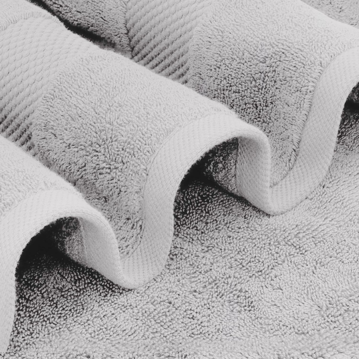 White Classic luxury bath sheet in a towel pile emphasizes plush absorbency