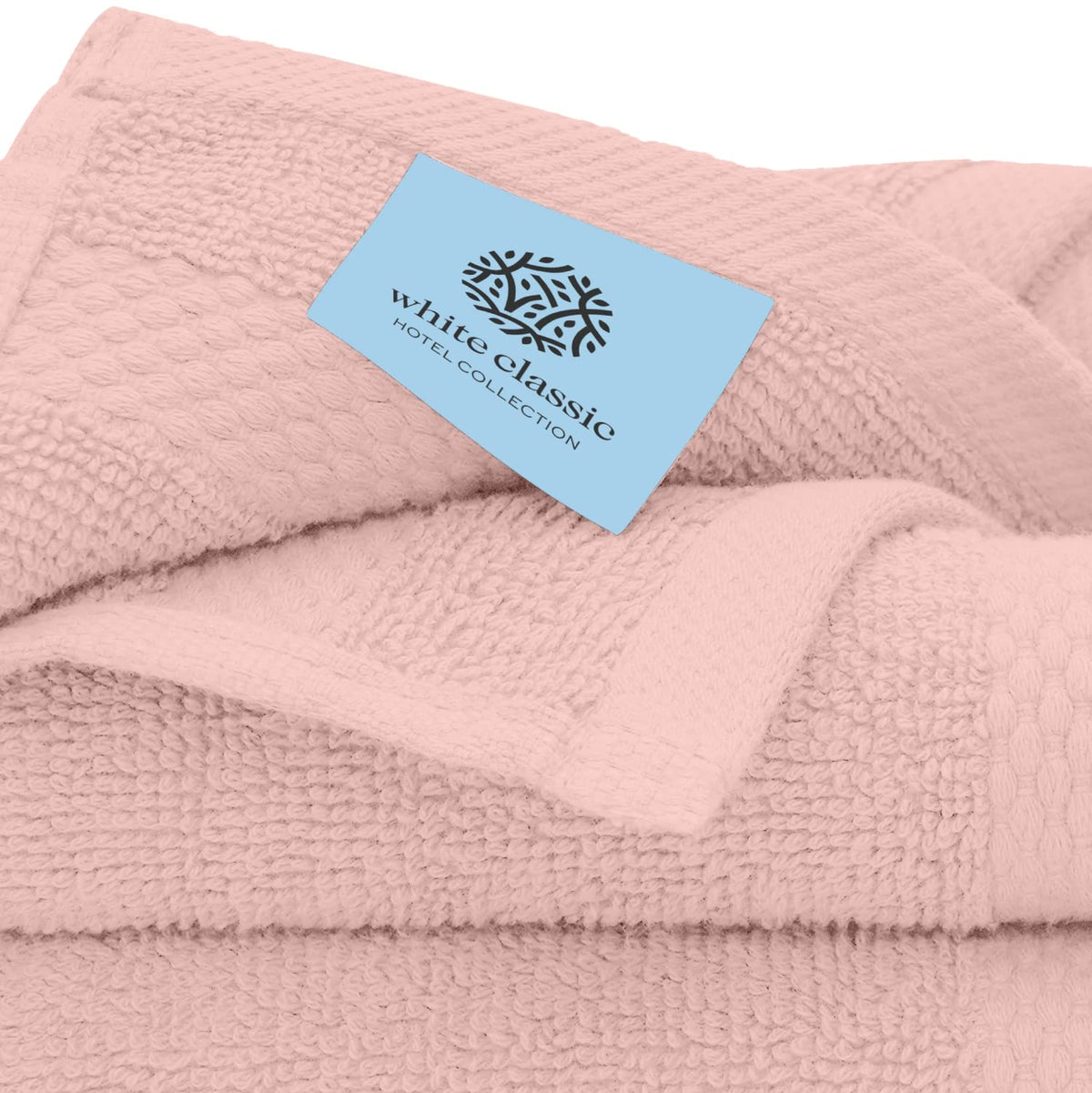 White Classic washcloths in laundry basket show quick-dry feature after washing.
