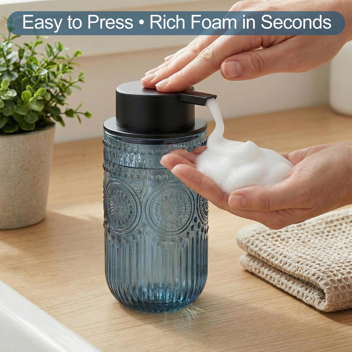 Wikapy blue glass foam dispenser, top pump close-up, easy press for rich foam.