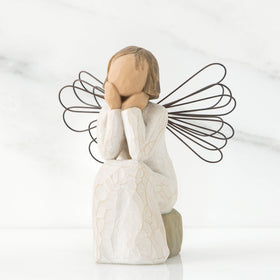 Willow Tree Angel of Caring wearing cream dress with wire wings, evokes calm presence.