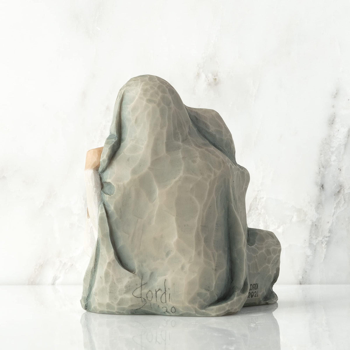 Willow Tree resin figure by Susan Lordi enhances decor with artisanal detail.