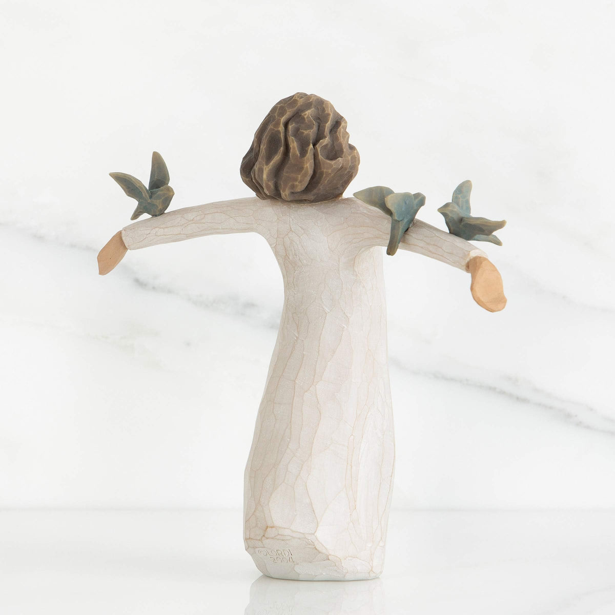Willow Tree Happiness cream dress figure, hand-painted detail for display.