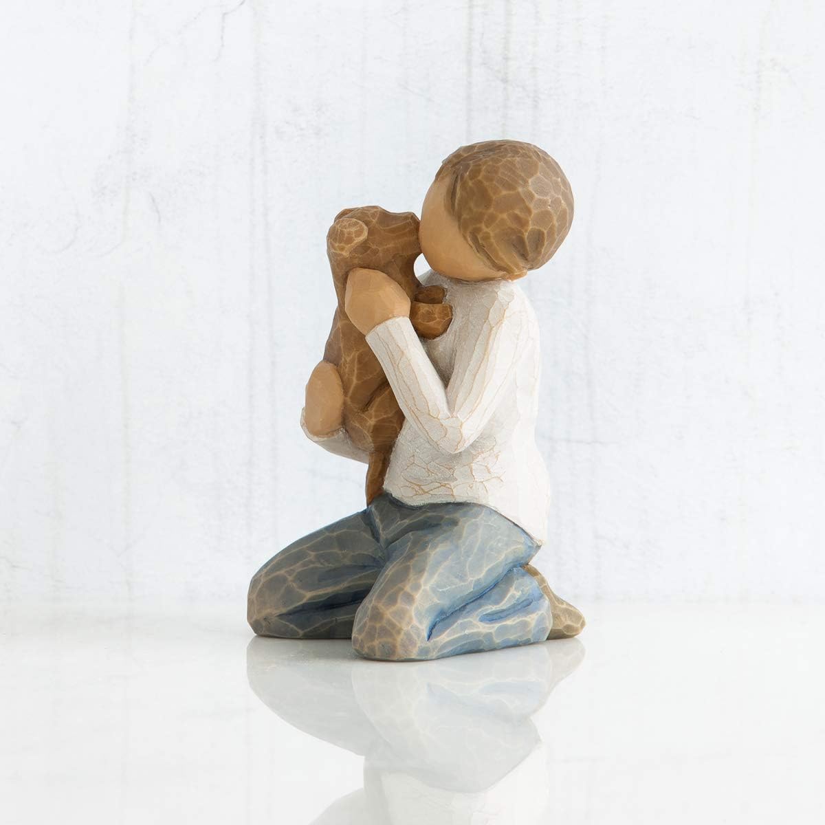 Close-up of hand-painted resin details on the Willow Tree Kindness boy figure