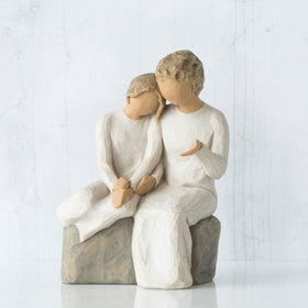 Willow Tree older-woman-on-bench-with-young-girl display highlighting intergenerational bond.