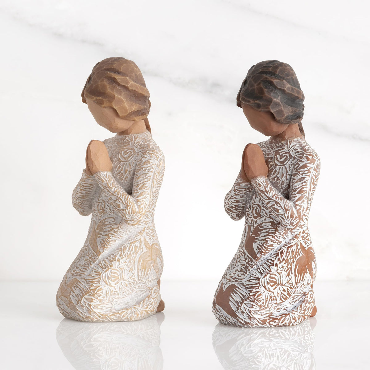 Darker skin Willow Tree figure displayed on a shelf for quiet reflection.