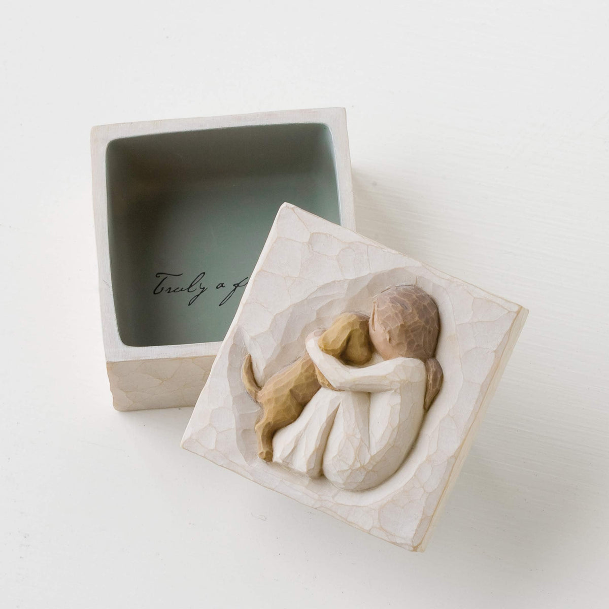Willow Tree True cream dress seated figure on lid close-up.