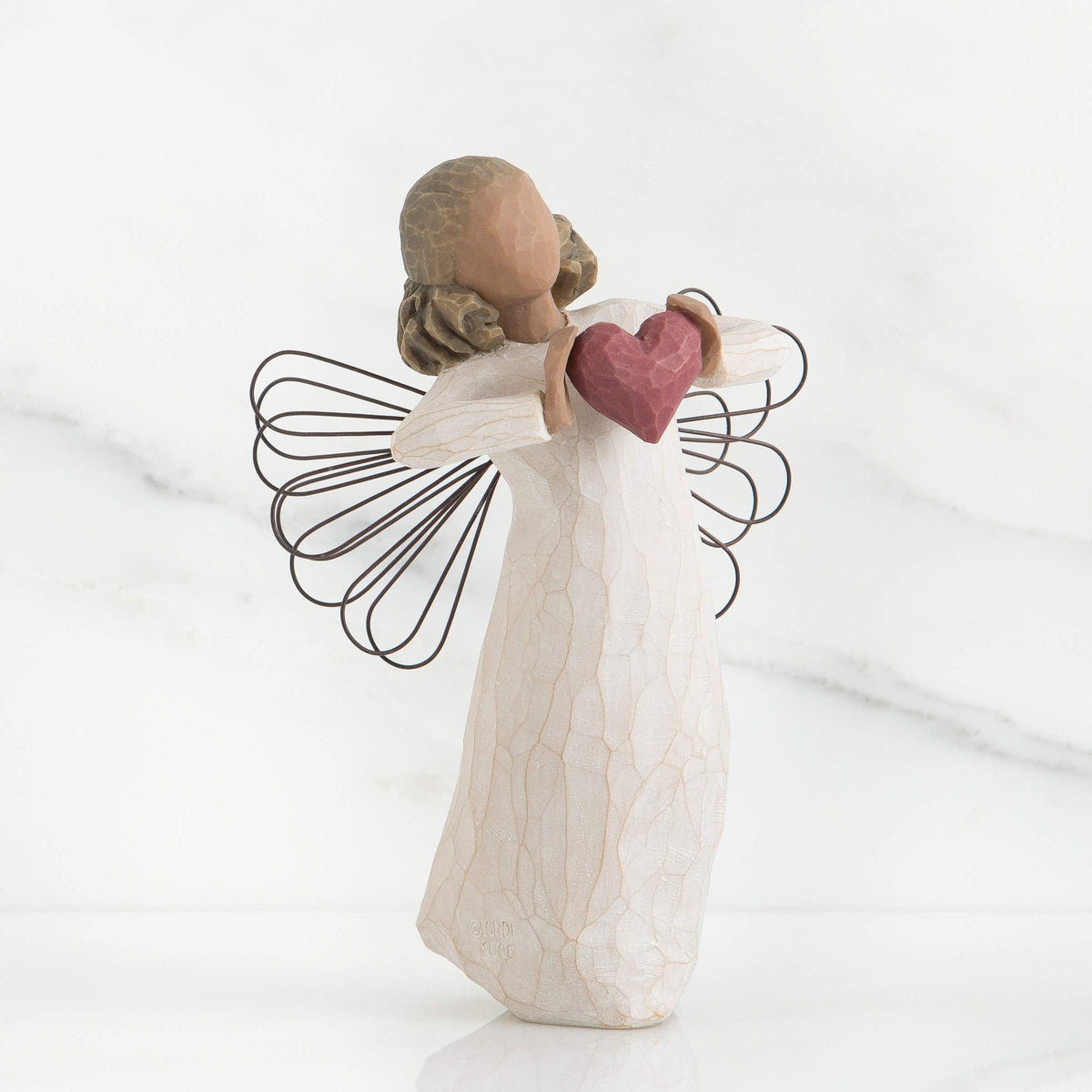 Willow Tree hand-painted resin figure showcasing artisan craftsmanship.