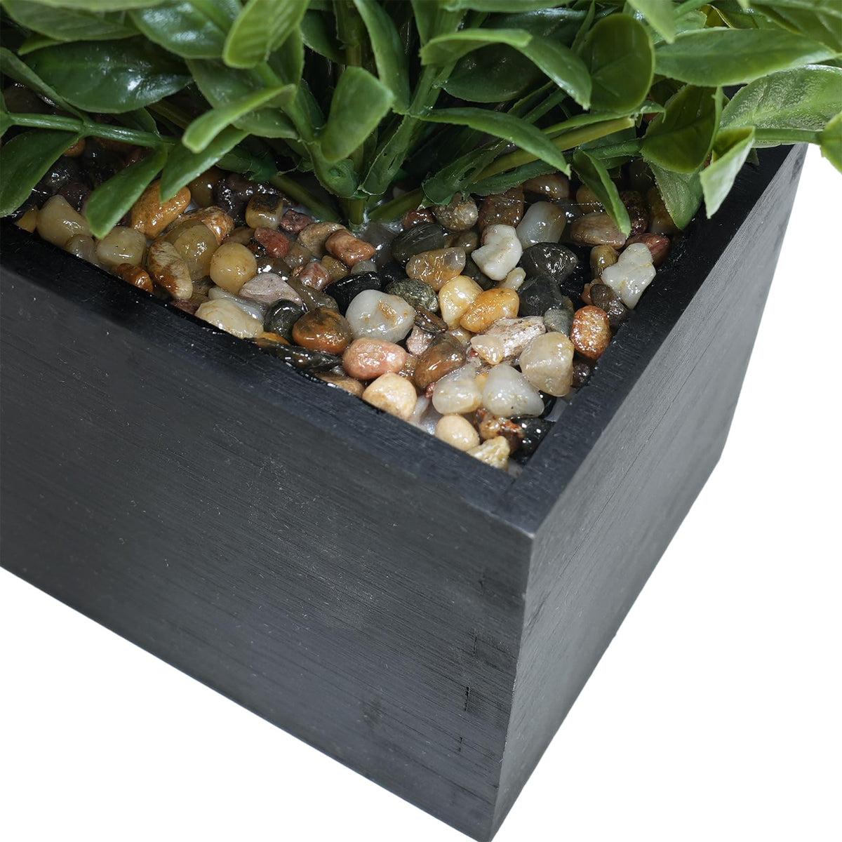 Close-up of lifelike boxwood leaves in the Winlyn planter, adding greenery with no maintenance.