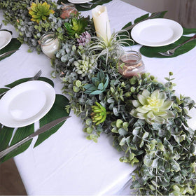 Winlyn eucalyptus garland styling around a wedding backdrop for natural texture.
