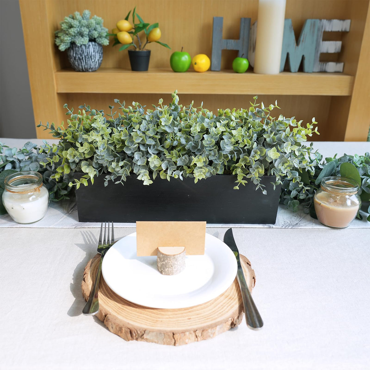 Thoughtful housewarming gift: Winlyn eucalyptus arrangement in a stylish planter.