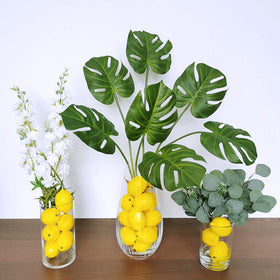 Winlyn lemon-faux-fruits vase filler adds sunny ambience to your table settings.