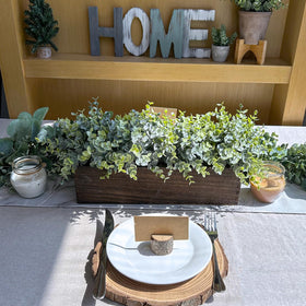 Winlyn pebbles in wooden planter create a polished, finished look.