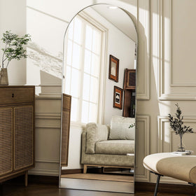 WISSMIELS silver arched mirror adds refined style to bedroom decor.