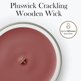 WoodWick Cinnamon Chai candle lit, warm aroma and cozy glow.
