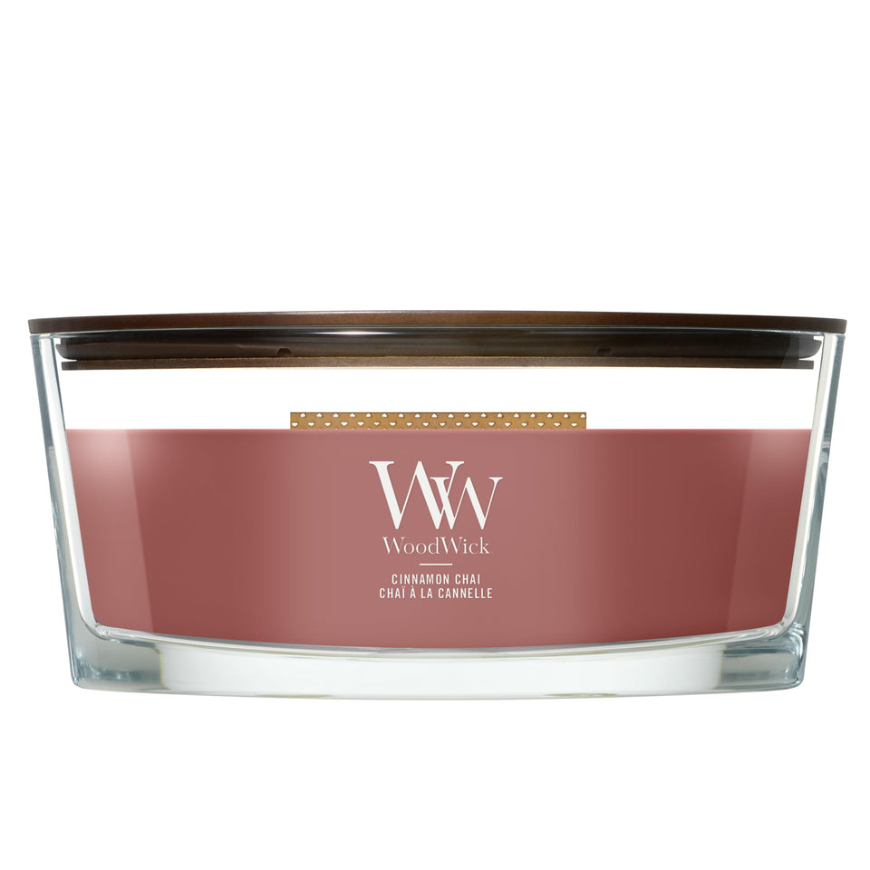 WoodWick Cinnamon Chai ellipse candle with warm fragrance diffusion.