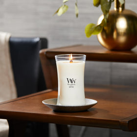 WoodWick Large Hourglass Candle White Teak on a mantel creates inviting warmth.