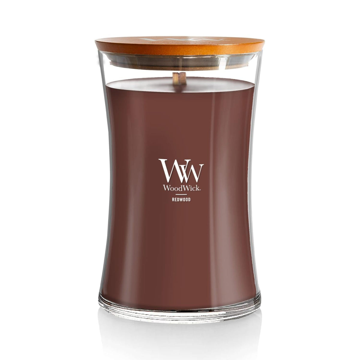 WoodWick Redwood Hourglass Candle emitting warm glow for cozy ambiance